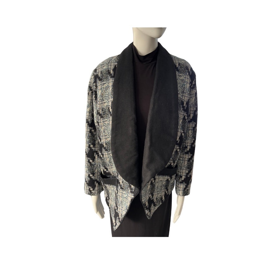 Mannequin wearing a patterned jacket over a black shirt on a white background