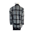 Houndstooth patterned jacket on a mannequin against a white background