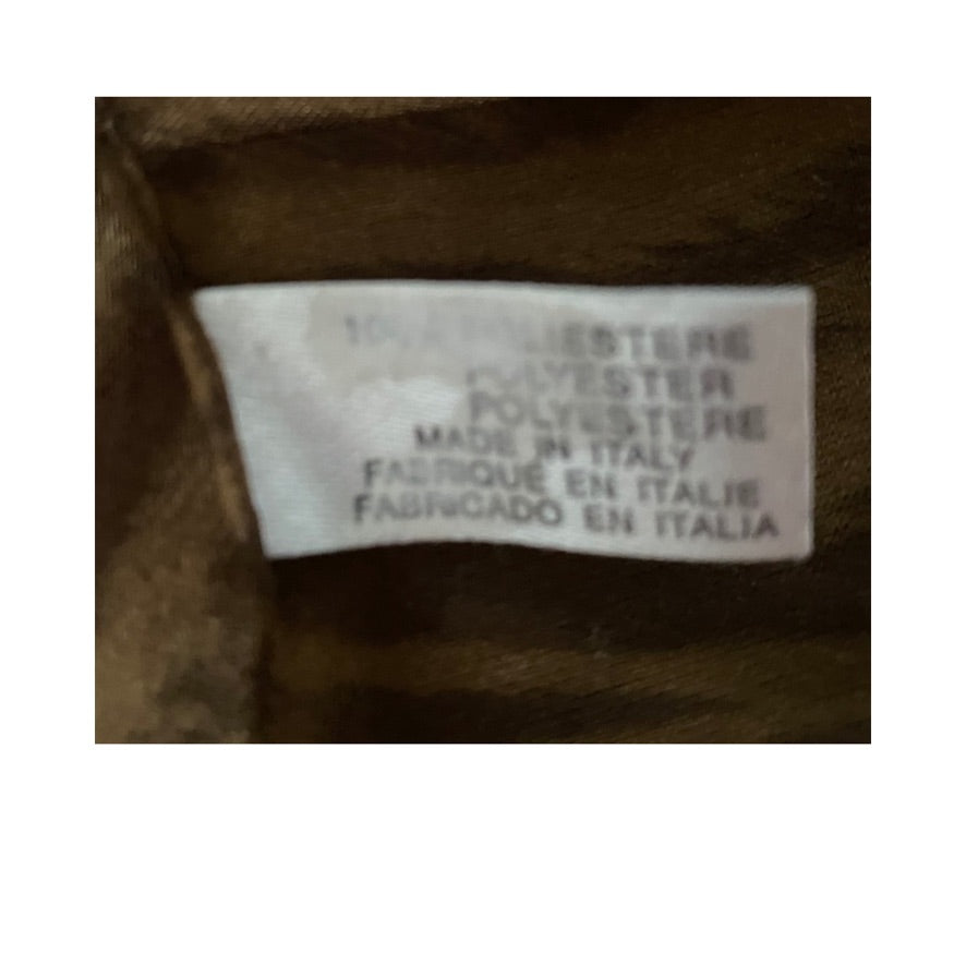 Fabric label on brown fabric indicating polyester and made in Italy.