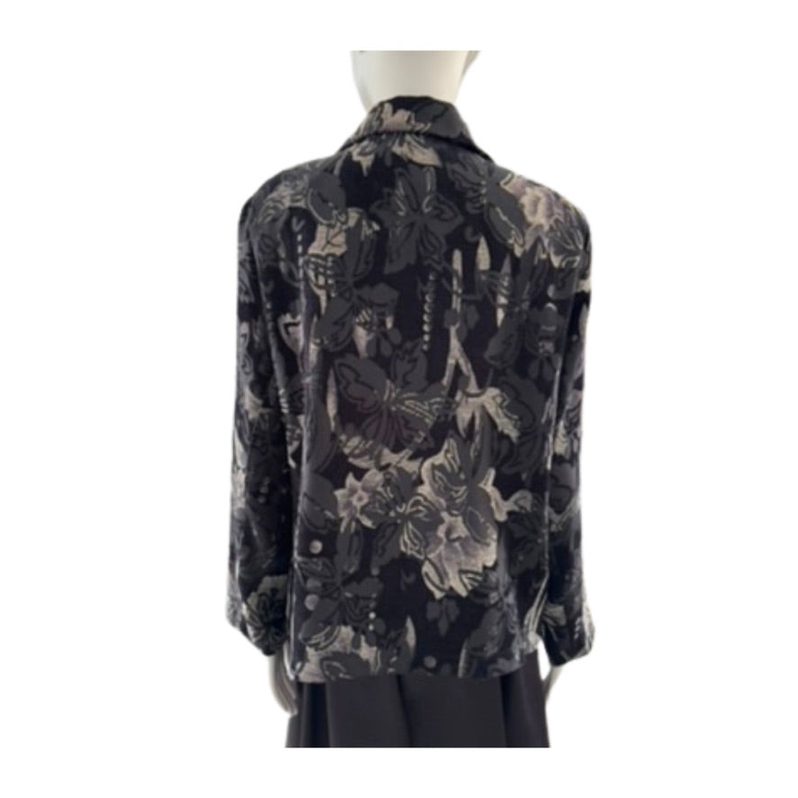 Black floral patterned blouse on a mannequin against a white background