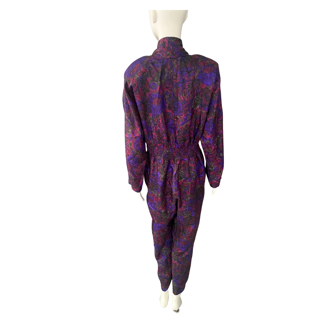 Multicolored patterned jumpsuit on a mannequin against a white background