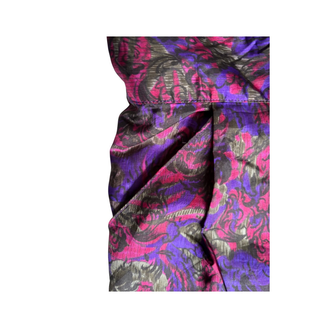 Close-up of a colorful patterned fabric with pink, purple, and black colors on a white background.