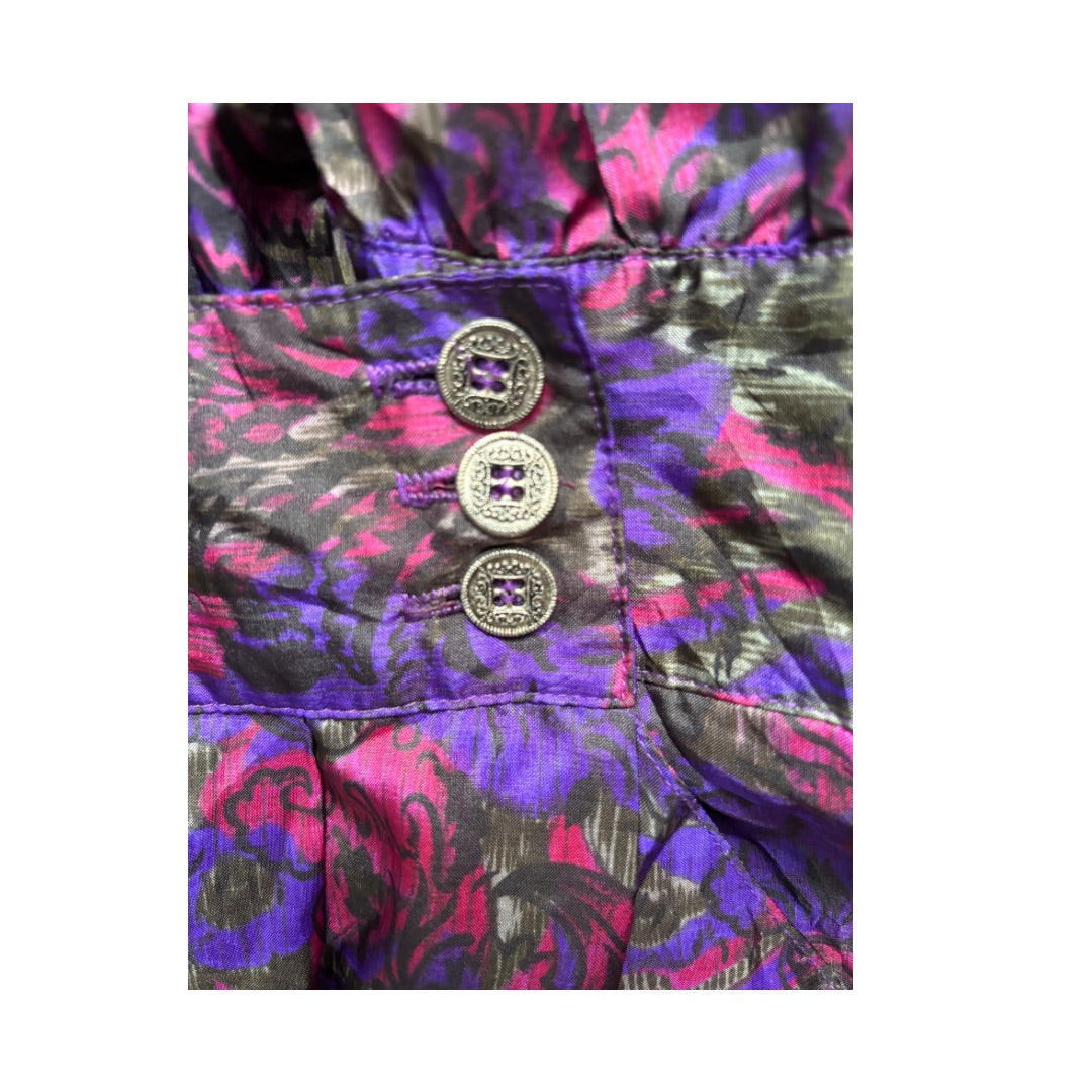 Close-up of a patterned fabric with buttons on a white background