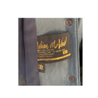 Close-up of a leather jacket with a brand label on a white background