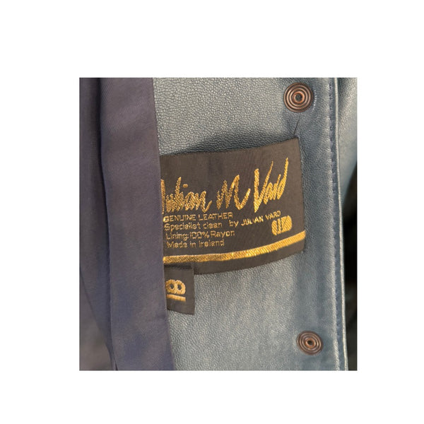 Close-up of a leather jacket with a brand label on a white background