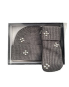 Grey knit hat and mittens set with decorative elements in a box on a white background