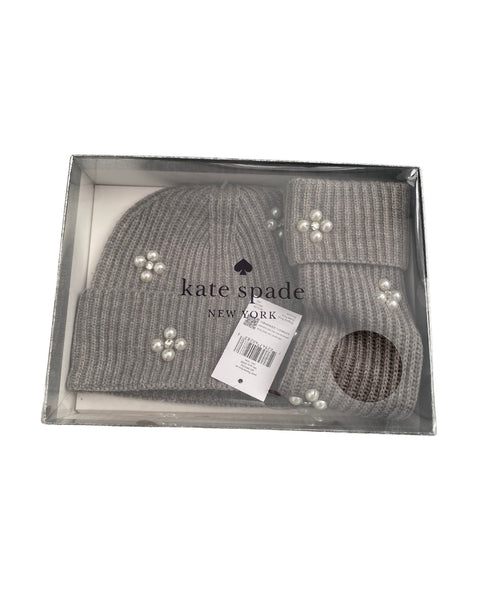 Gray knit beanie with pearl embellishments in a Kate Spade box on a white background