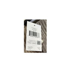 Clothing tag with barcode and text on a textured fabric background