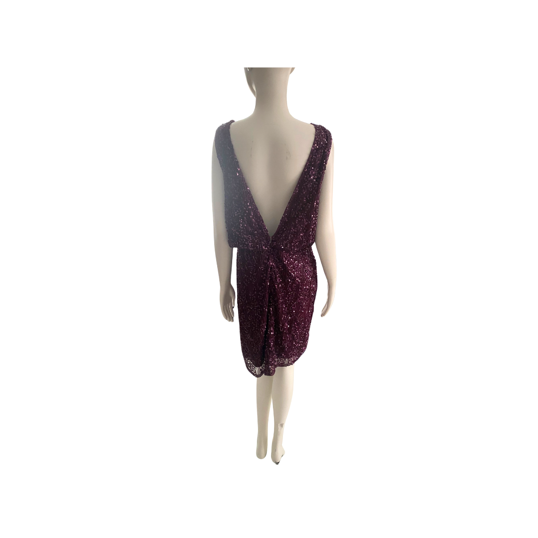 Mannequin wearing a sparkly burgundy dress on a white background