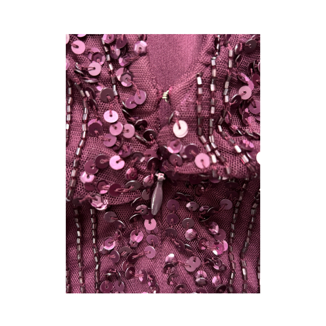 Close-up of a purple sequined fabric with a white background