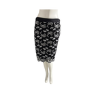 Black pencil skirt with white floral pattern on a mannequin against a white background