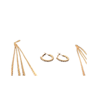 Gold earrings including hoop and fringe designs on a white background