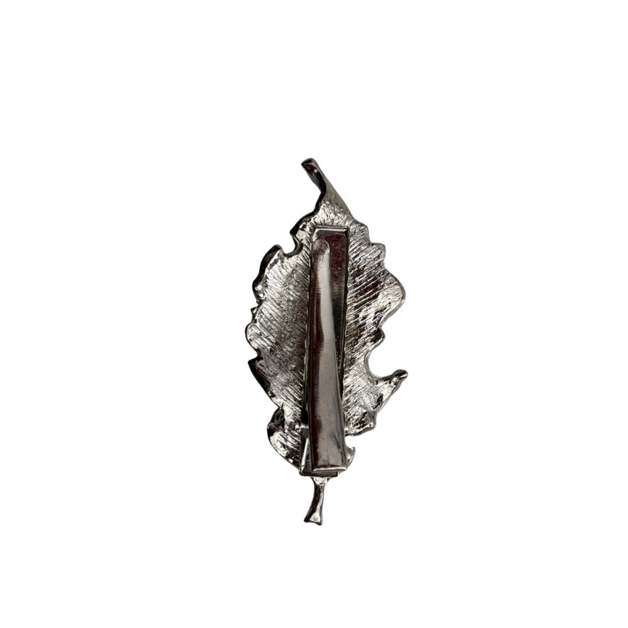 Silver leaf-shaped object on a white background