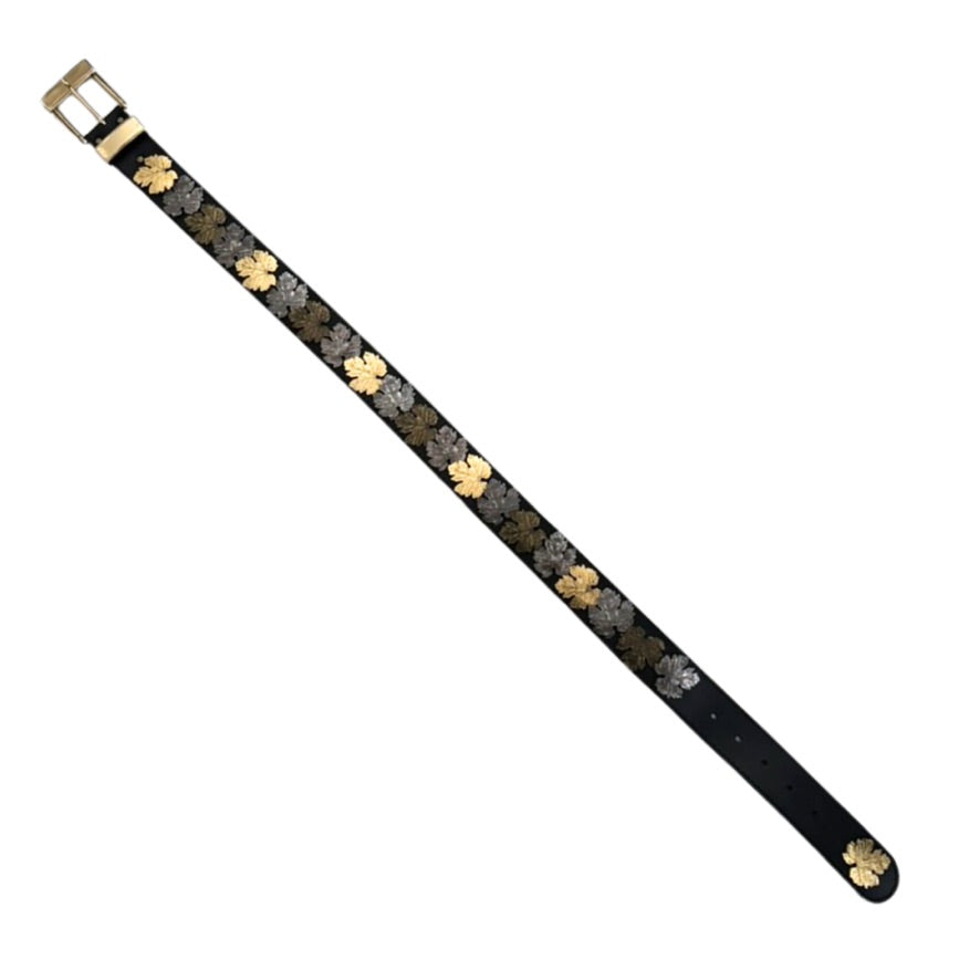 Black leather belt with gold floral patterns on a white background
