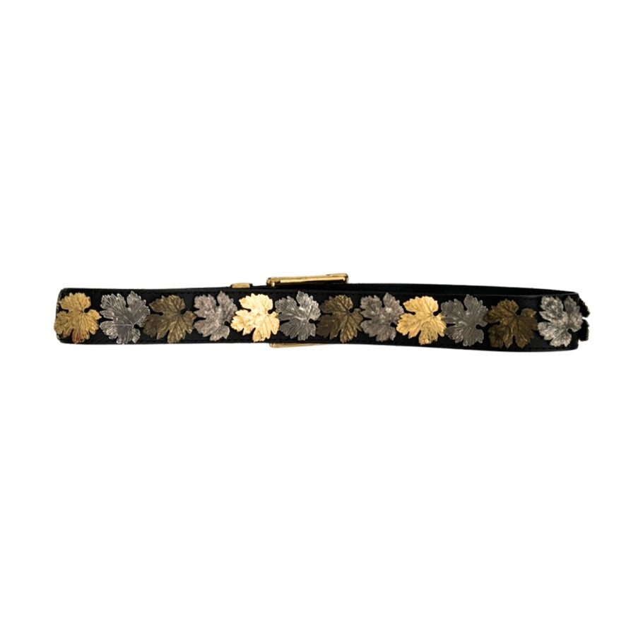 Black belt with gold and silver floral patterns on a white background