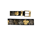 Belt with leaf designs and a gold buckle on a white background
