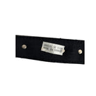 Black leather strap with a silver tag labeled 'Crète de Cuir Made in France' on a white background