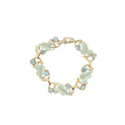 Bracelet with leaf designs and gemstones on a white background