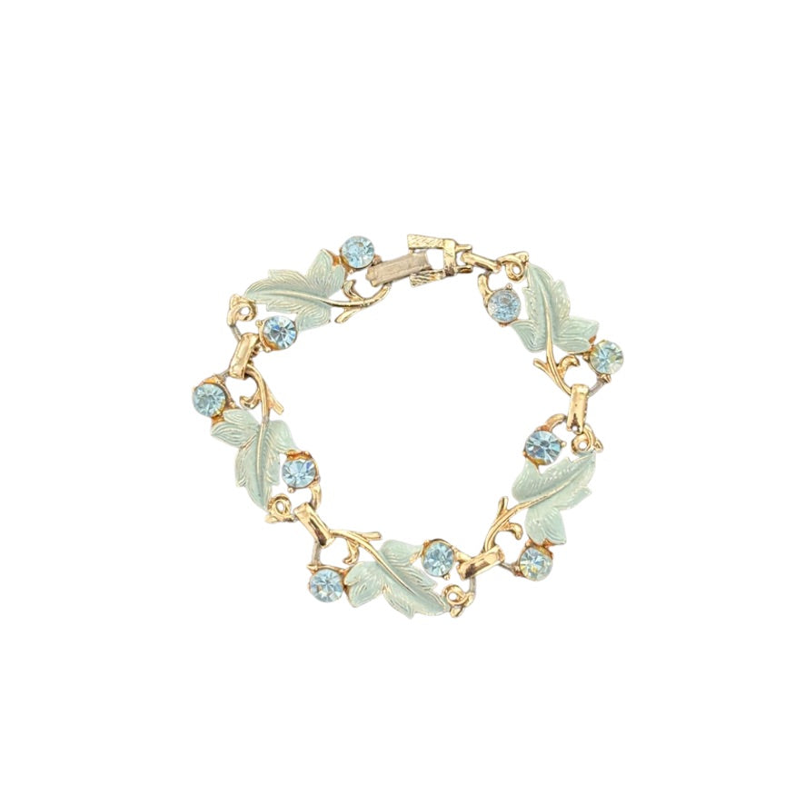 Bracelet with leaf designs and gemstones on a white background