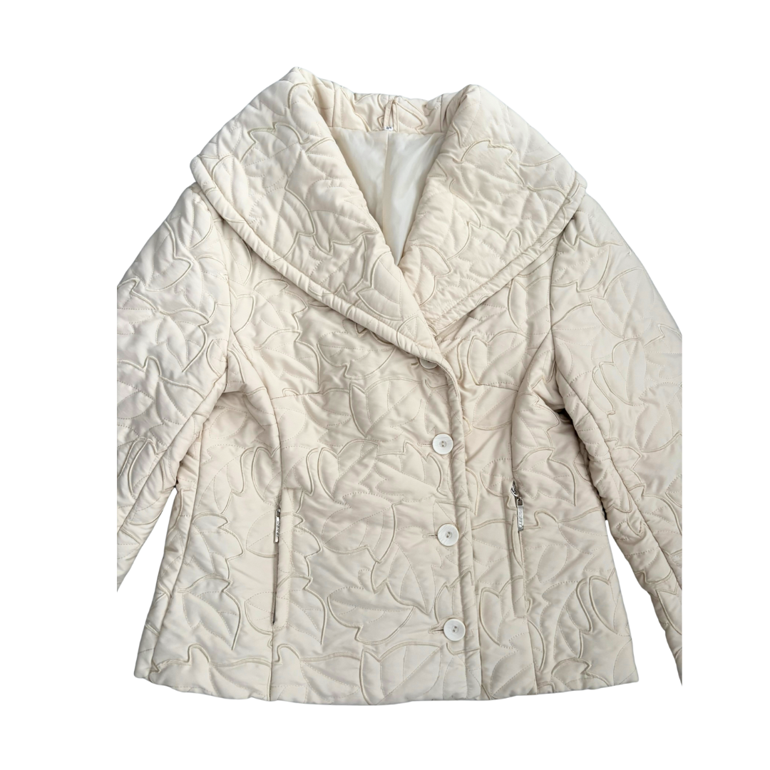 Beige quilted jacket with leaf pattern on a white background