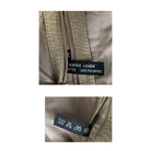 Close-up of a label on a beige jacket with text and symbols.