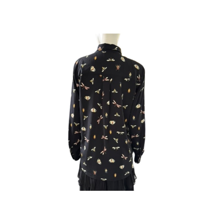 Black dress with butterfly pattern on a mannequin against a white background