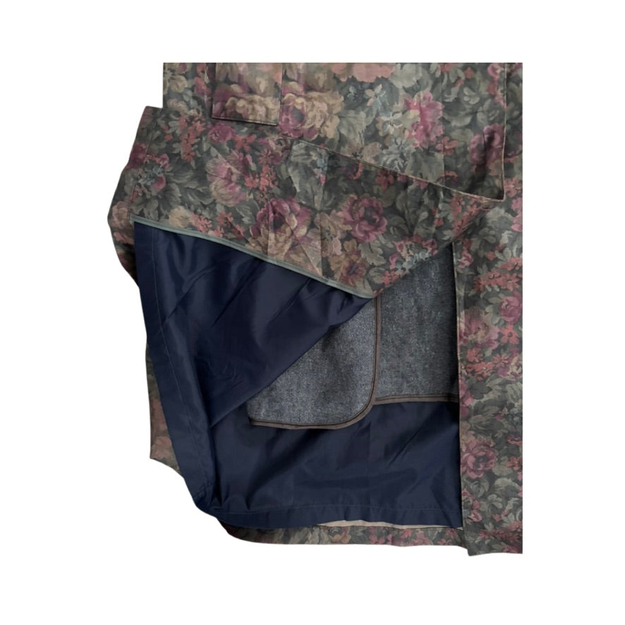 Floral-patterned blanket with a dark blue interior on a white background