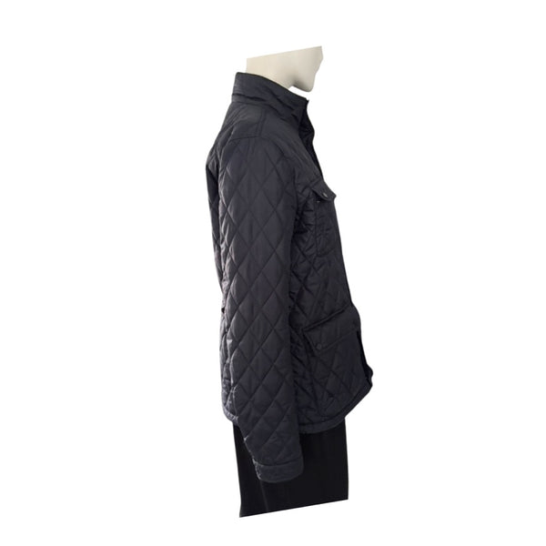 Navy quilted jacket on a mannequin against a white background