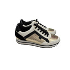 Pair of black and white sneakers with snake skin pattern on a white background