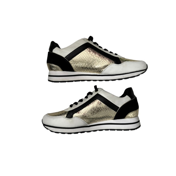 White sneakers with black and gold accents on a white background