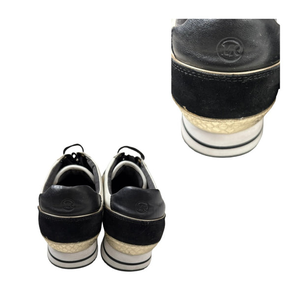 Black and gold shoes with a close-up of the sole on a white background