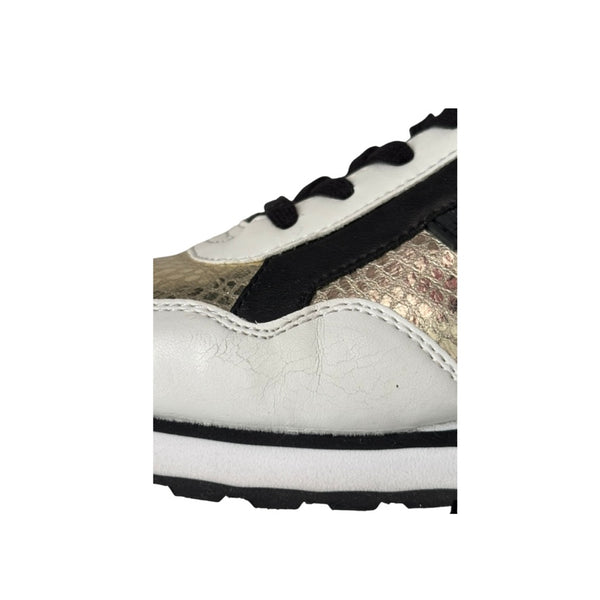 Close-up of a white sneaker with black laces and sole on a white background
