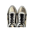 Pair of snakeskin-patterned sneakers with black laces on a white background