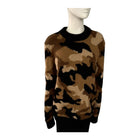 Camouflage-patterned sweater on a mannequin against a white background