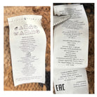 Two clothing labels with text and symbols on a textured background