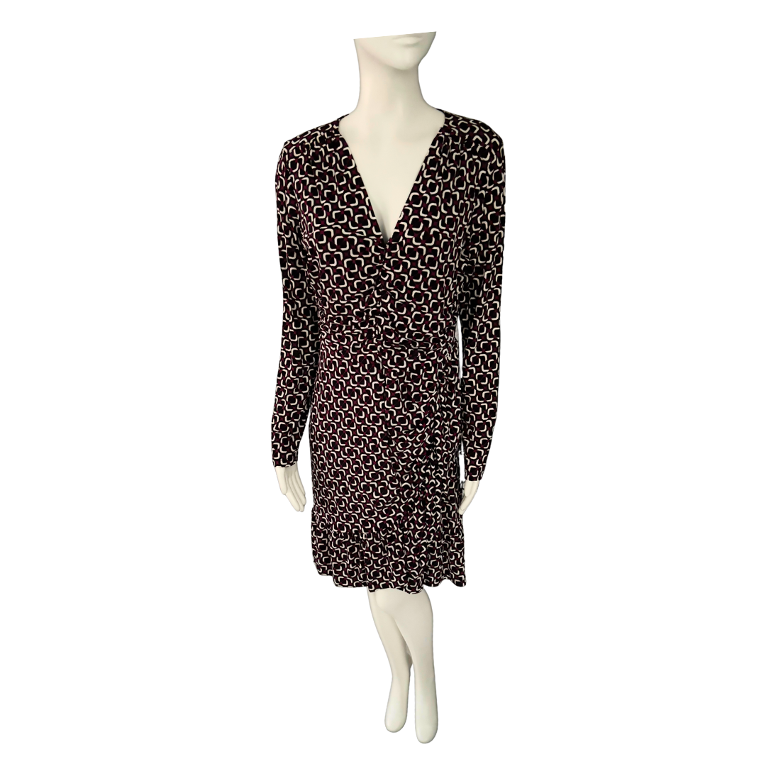 Black patterned dress on a mannequin against a white background