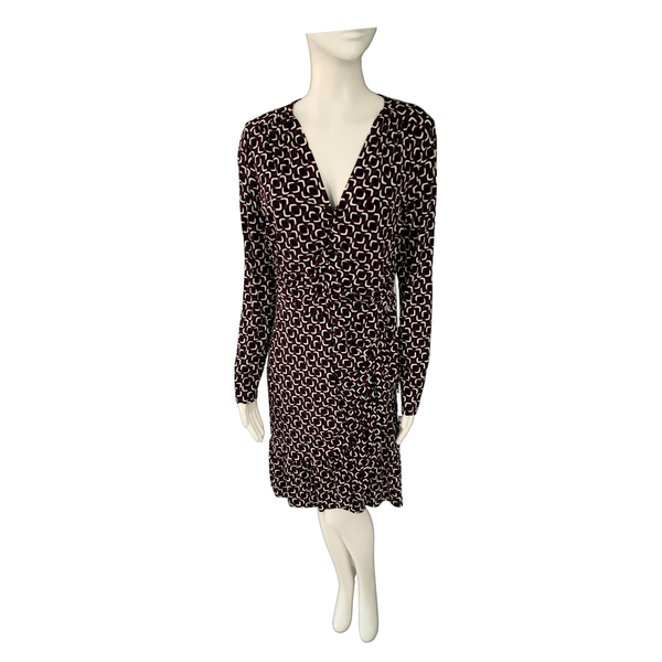 Black patterned dress on a mannequin against a white background