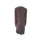 Maroon, black and white patterned dress on a mannequin against a white background