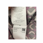 Close-up of a Michael Kors label on a patterned fabric background