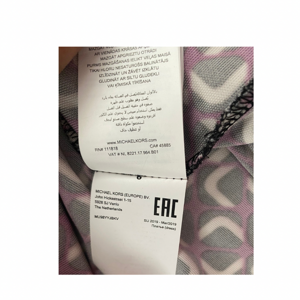 Close-up of a Michael Kors label on a patterned fabric background