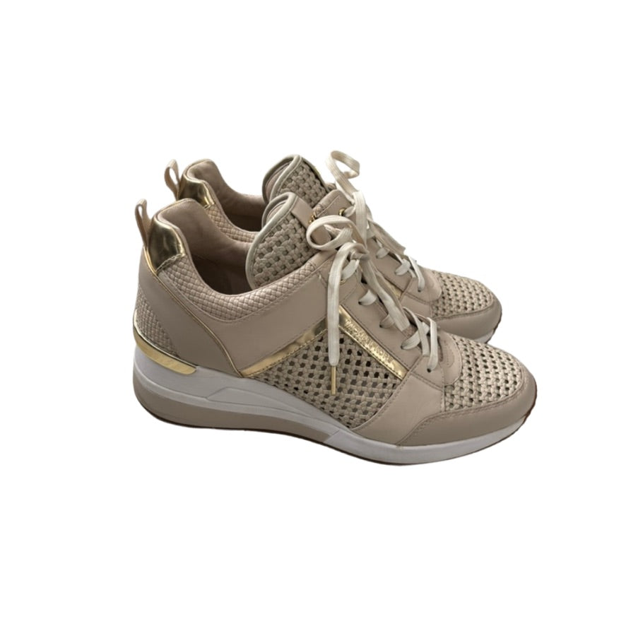 Beige sneakers with gold accents on a white background