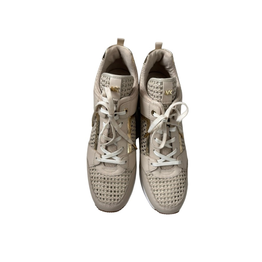Pair of beige sneakers with white laces on a white background