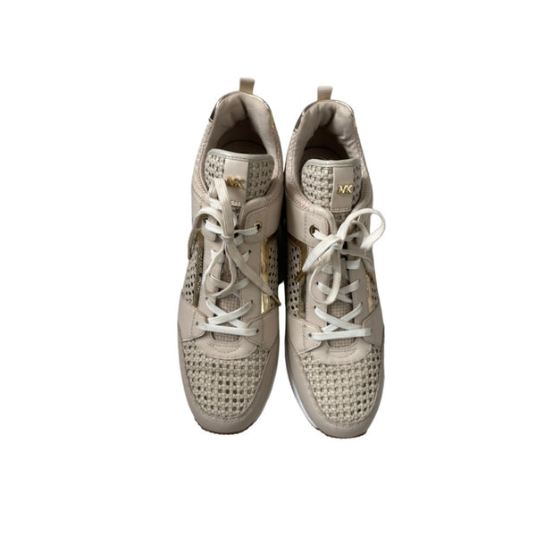Pair of beige sneakers with white laces on a white background