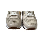 Pair of beige sneakers with white laces on a white background