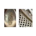 Close-up of Michael Kors logo on a shoe and shoe sole texture.