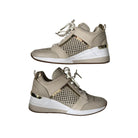 Beige and white sneakers with gold accents on a white background