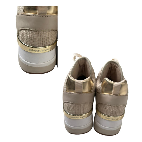 Pair of beige and gold sneakers with white soles on a white background