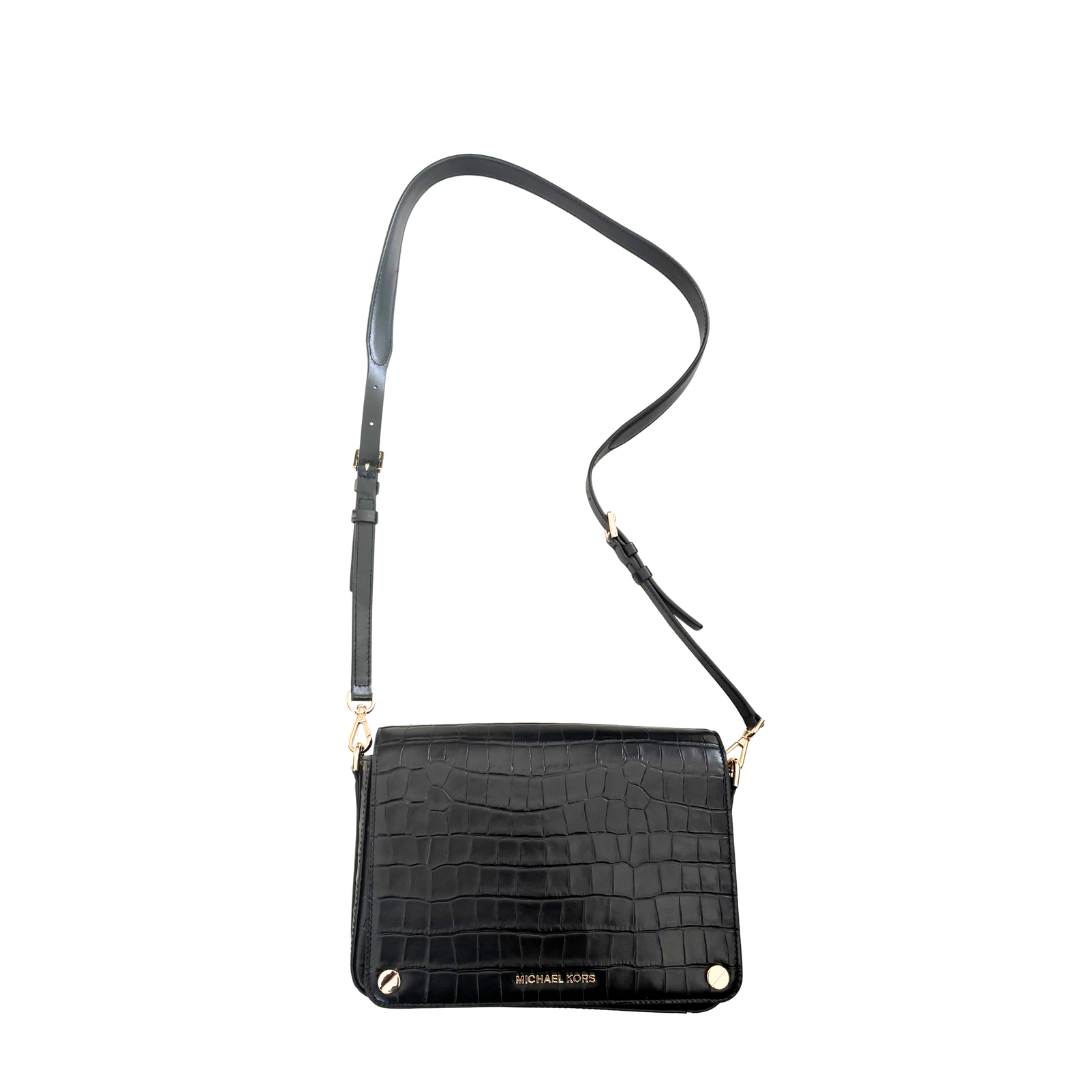Black crocodile-patterned handbag with a strap on a white background