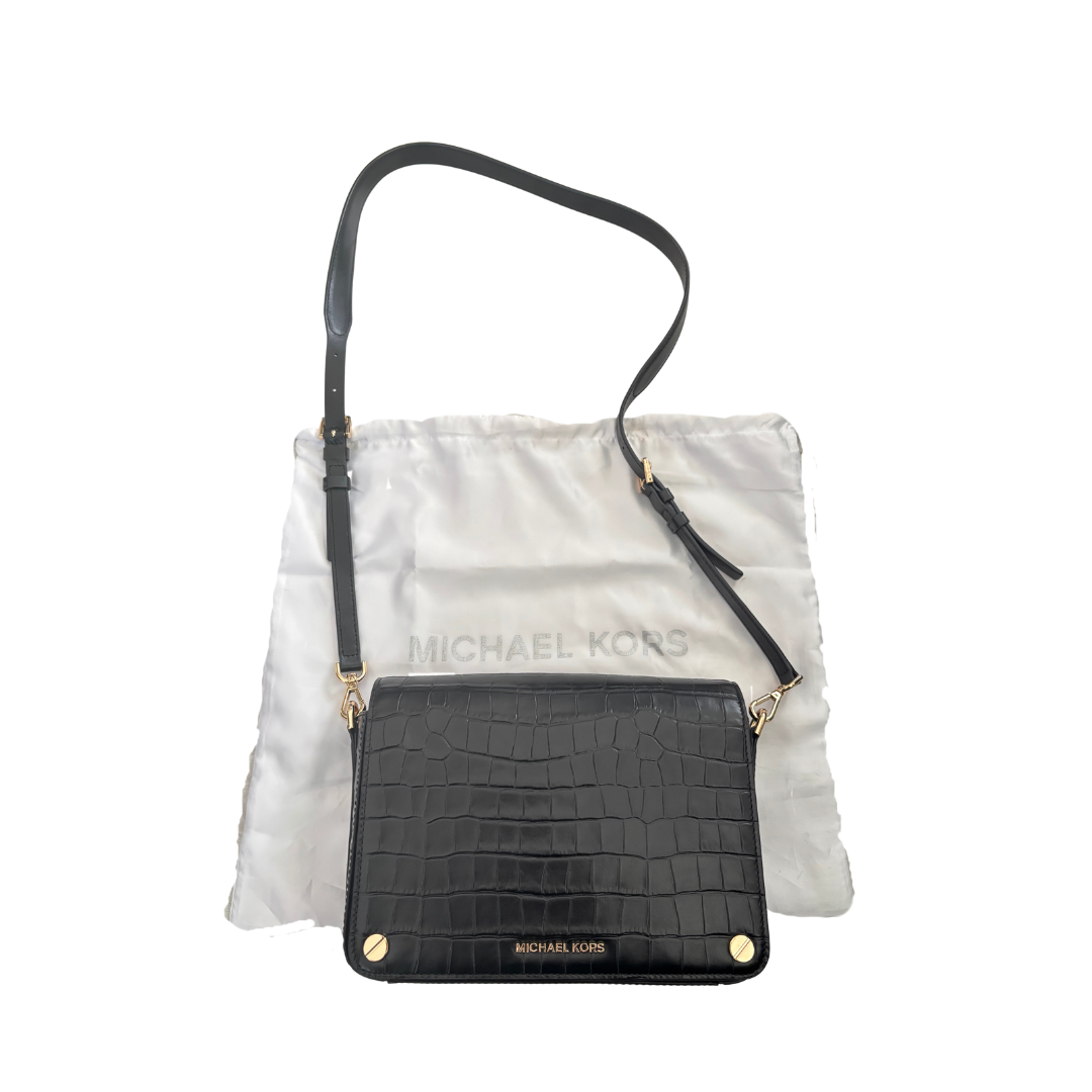 Michael Kors handbag with black crocodile-textured flap on a white background