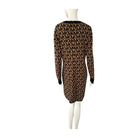 Black and brown patterned dress on a mannequin against a white background